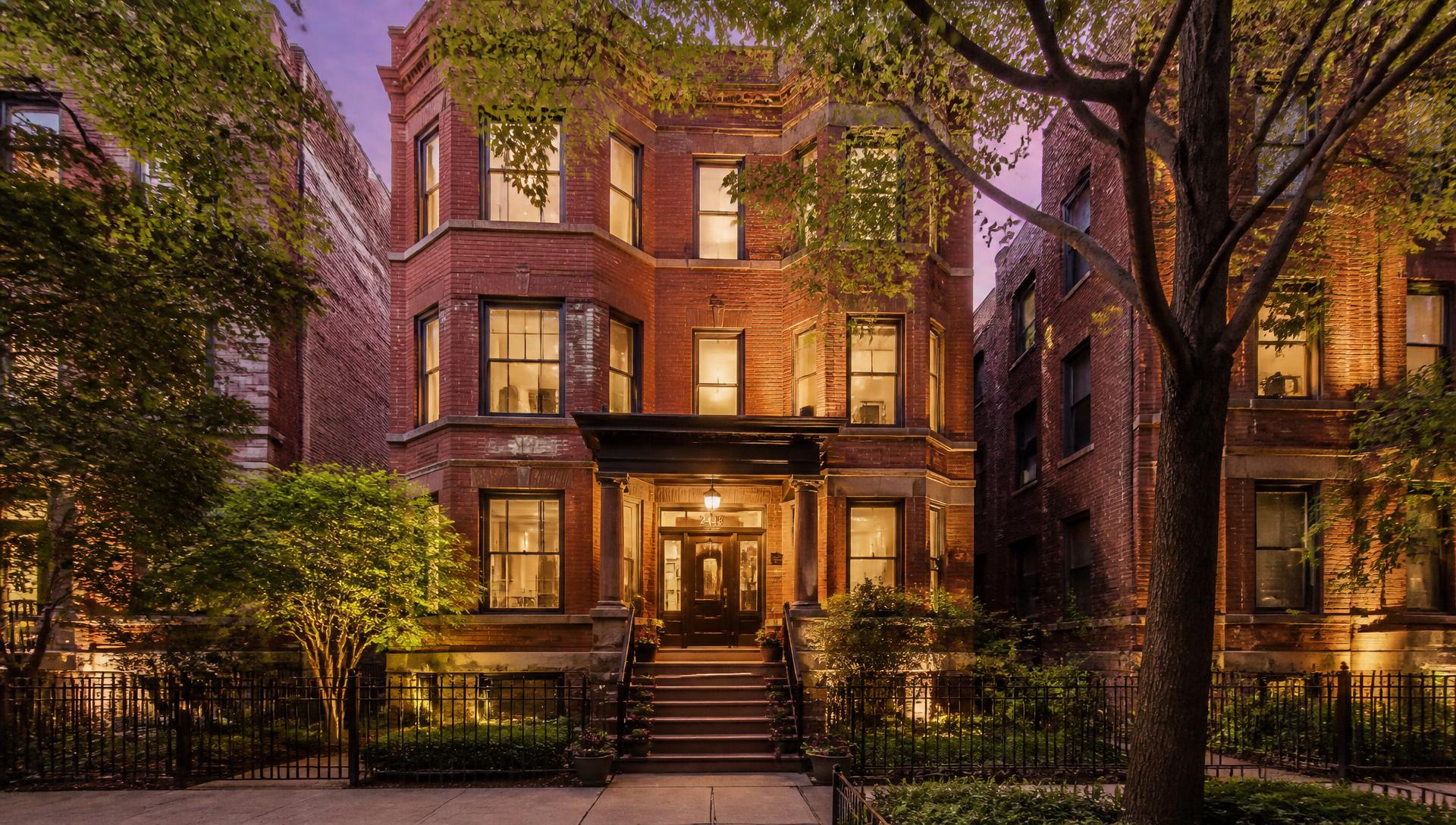 A warmly lit Chicago three-flat at golden hour